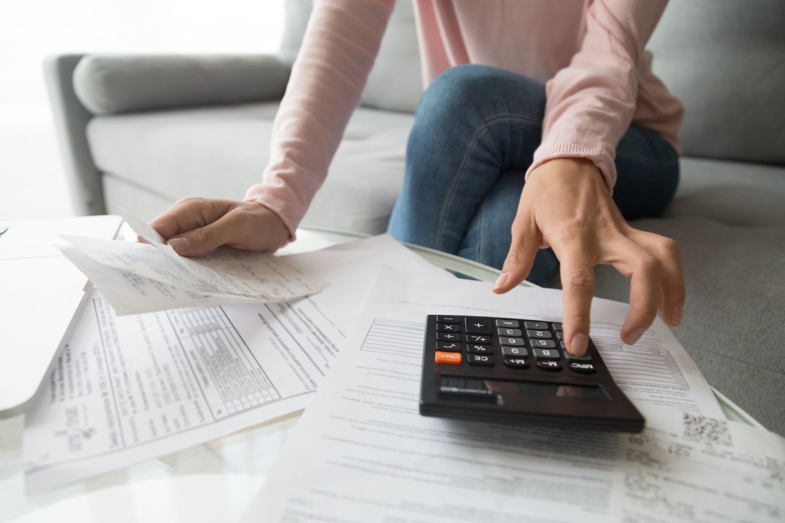 A woman evaluating finances before submitting a hard money loan application